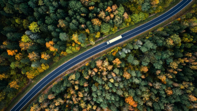 Aerial view of heavy truck on a narrow twisting road