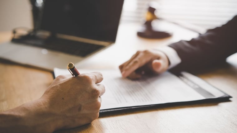 Hand signing an official document