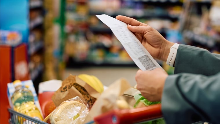 Woman checking receipt at grocery store