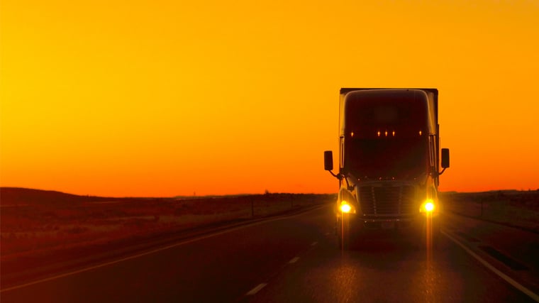 Semi-Truck Driving At Sunset